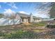 Exterior view of the backyard showing a fenced yard with a well-maintained lawn area and the house's rear facade at 55 Vintage Dr, Covington, GA 30014