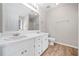 Bright bathroom featuring double sinks, a large mirror, and wood-look flooring at 55 Vintage Dr, Covington, GA 30014