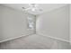 Comfortable bedroom features neutral carpet, ample natural light, and ceiling fan at 55 Vintage Dr, Covington, GA 30014