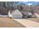 View of the house showing the driveway and a two-car garage attached to the home at 55 Vintage Dr, Covington, GA 30014