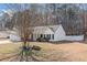 Single-story home with neutral siding and a well-maintained lawn and landscaping at 55 Vintage Dr, Covington, GA 30014