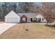 Charming single-story home with a well-manicured front yard, two-car garage, and inviting entrance at 55 Vintage Dr, Covington, GA 30014