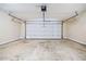 View of the garage featuring concrete floors, a white door, and an automatic door opening mechanism on the ceiling at 55 Vintage Dr, Covington, GA 30014