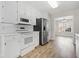 Well-lit kitchen equipped with white cabinets, stainless steel refrigerator, and modern appliances at 55 Vintage Dr, Covington, GA 30014