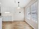 Eat-in kitchen featuring wood flooring, white walls, and modern window treatments at 55 Vintage Dr, Covington, GA 30014