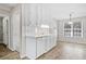 Bright kitchen features white cabinets, tile backsplash, wood floors, and a window that provides natural light at 55 Vintage Dr, Covington, GA 30014