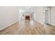 Open-concept living room with a cozy brick fireplace and laminate flooring at 55 Vintage Dr, Covington, GA 30014