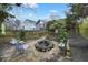 Backyard with a stone patio, a tranquil fountain, and a wooden fence with greenery at 818 Virgil Ne St, Atlanta, GA 30307