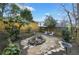 Landscaped backyard featuring a stone patio, small fountain, bird bath, and wooden fence at 818 Virgil Ne St, Atlanta, GA 30307