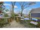 Cozy wooden deck with a blue table and chairs surrounded by lush greenery and trees at 818 Virgil Ne St, Atlanta, GA 30307