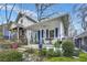 Charming craftsman-style home featuring a welcoming front porch and lush landscaping at 818 Virgil Ne St, Atlanta, GA 30307