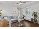Cozy living room featuring hardwood floors, comfortable sofa, and bench near window at 818 Virgil Ne St, Atlanta, GA 30307