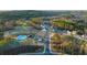 Aerial shot of a new construction community featuring a pool and tennis courts at 1868 Lacebark Elm Way, Lawrenceville, GA 30045