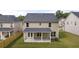 View of the backyard featuring a covered patio and well-maintained lawn at 1868 Lacebark Elm Way, Lawrenceville, GA 30045