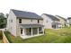 Rear of home featuring a covered patio and expansive backyard at 1868 Lacebark Elm Way, Lawrenceville, GA 30045