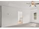 View of a bedroom featuring an open door and a glimpse of the backyard through the window at 1868 Lacebark Elm Way, Lawrenceville, GA 30045
