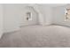 A spacious bedroom with neutral-toned carpet, and natural light from two windows at 1868 Lacebark Elm Way, Lawrenceville, GA 30045