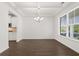 Dining area with hardwood floors, bright window, and elegant lighting, seamlessly connecting to the modern kitchen at 1868 Lacebark Elm Way, Lawrenceville, GA 30045