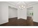 Open dining area featuring hardwood floors, decorative ceiling and chandelier at 1868 Lacebark Elm Way, Lawrenceville, GA 30045