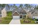 Charming two-story home with brick and siding, complemented by a well-manicured lawn and attached two-car garage at 1868 Lacebark Elm Way, Lawrenceville, GA 30045