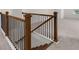 Hallway featuring stairs with black metal railings and wood trim at 1868 Lacebark Elm Way, Lawrenceville, GA 30045