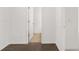 Hallway featuring hardwood floors and white walls with entryways at 1868 Lacebark Elm Way, Lawrenceville, GA 30045