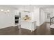Open kitchen with a large center island, stainless appliances, and modern design at 1868 Lacebark Elm Way, Lawrenceville, GA 30045