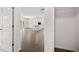 View from closet toward open concept kitchen, living, and dining areas at 1868 Lacebark Elm Way, Lawrenceville, GA 30045
