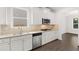 Kitchen features stainless steel appliances, granite countertops, and white cabinetry at 1868 Lacebark Elm Way, Lawrenceville, GA 30045