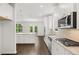 Bright kitchen featuring stainless appliances, a large island, and pendant lighting at 1868 Lacebark Elm Way, Lawrenceville, GA 30045