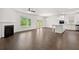Bright and airy living room open to the kitchen with an island and stainless appliances at 1868 Lacebark Elm Way, Lawrenceville, GA 30045