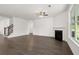 Open concept living room with fireplace and a staircase with wood and metal banister at 1868 Lacebark Elm Way, Lawrenceville, GA 30045