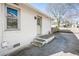 Exterior shot of home showing a concrete patio leading to the backyard with a white brick wall at 2976 Emory Se Rd, Smyrna, GA 30080