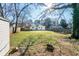 Large backyard showcasing ample green space, a shed, perimeter fencing, and mature trees at 2976 Emory Se Rd, Smyrna, GA 30080