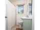Bright bathroom with a large mirror, a white sink, and a shower curtain creating a charming and practical space at 2976 Emory Se Rd, Smyrna, GA 30080