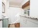 Light and airy bathroom with granite counters, a sink, a window with shade, and a shower with curtain at 2976 Emory Se Rd, Smyrna, GA 30080