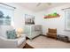Cozy Bedroom with a crib, chair, and ample natural light creates a comforting space for little ones at 2976 Emory Se Rd, Smyrna, GA 30080
