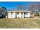 Charming white brick home featuring a well-maintained lawn and inviting front porch at 2976 Emory Se Rd, Smyrna, GA 30080