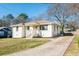 Charming white brick home featuring a well-maintained lawn and inviting front porch at 2976 Emory Se Rd, Smyrna, GA 30080