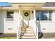 Close up of the home's inviting front porch with a decorative wreath and stone steps at 2976 Emory Se Rd, Smyrna, GA 30080