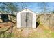 Exterior view of a gray and white storage shed set on gravel with a surrounding grass yard at 2976 Emory Se Rd, Smyrna, GA 30080