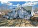 Backyard featuring a deck, mature trees, and green lawn at 115 Trelawney Cir, Covington, GA 30016