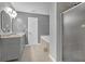 Bathroom featuring a bathtub, glass shower, double sink vanity, and neutral tile floors at 115 Trelawney Cir, Covington, GA 30016