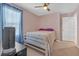 Bedroom with comfortable carpet, bright windows, and ample space at 115 Trelawney Cir, Covington, GA 30016