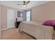 Cozy bedroom featuring a ceiling fan, natural light, and neutral carpeting at 115 Trelawney Cir, Covington, GA 30016