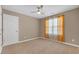 Bedroom featuring neutral paint, a ceiling fan, a window with orange curtains, and carpeted floors at 115 Trelawney Cir, Covington, GA 30016