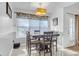Cozy dining area with a modern light fixture, a window, and seating for four at 115 Trelawney Cir, Covington, GA 30016