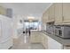 Bright kitchen with stainless steel appliances and a view into the adjacent dining area at 115 Trelawney Cir, Covington, GA 30016
