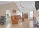 Open living area with vaulted ceilings, fireplace, and seamless flow to kitchen at 115 Trelawney Cir, Covington, GA 30016