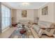 Neutral toned living room featuring comfortable seating, accent tables, and natural light at 115 Trelawney Cir, Covington, GA 30016